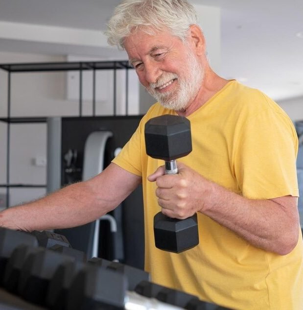 man wearing yellow shirt and doing exercise with dumble